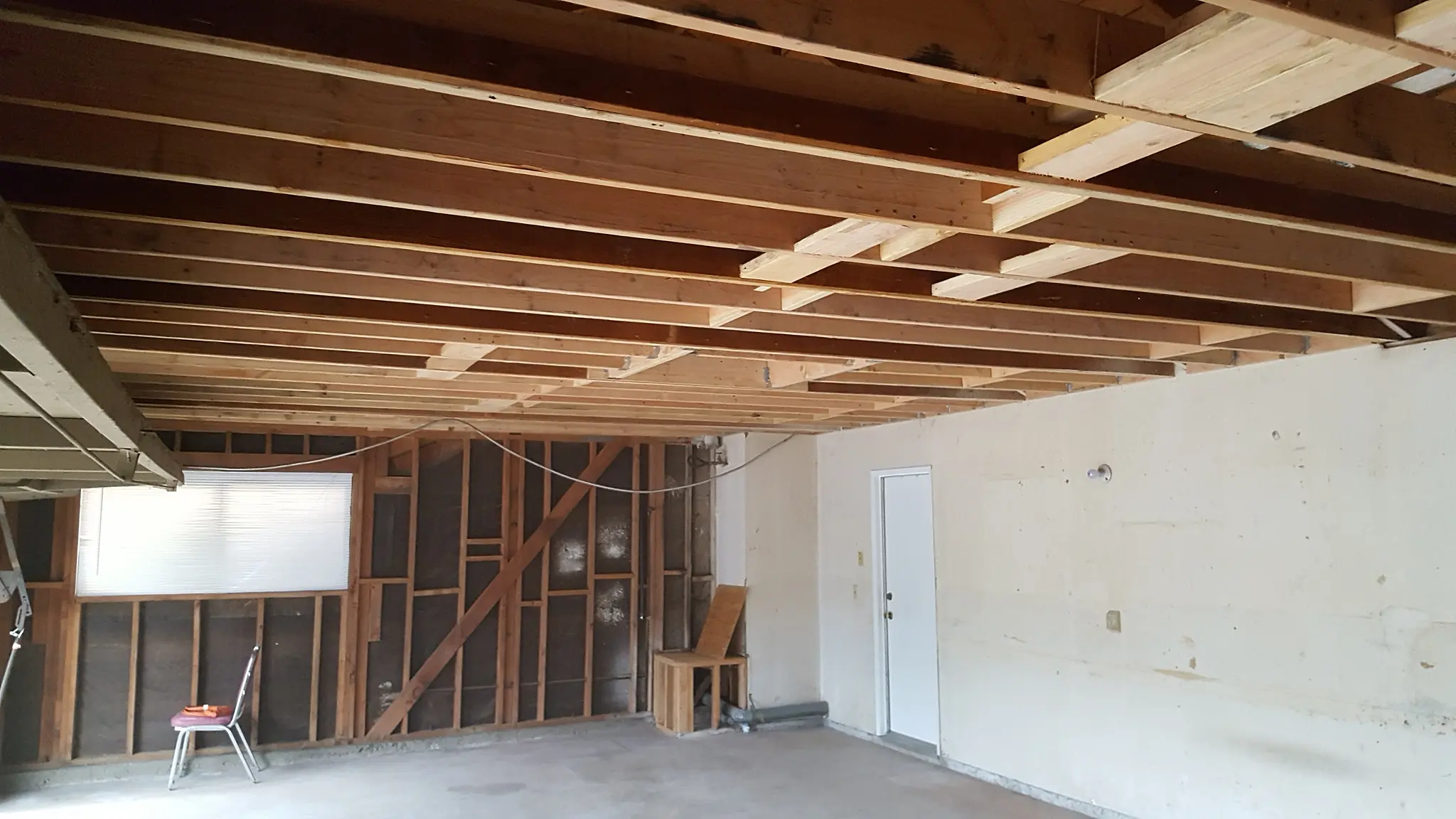 Exposed wooden ceiling drywall installation